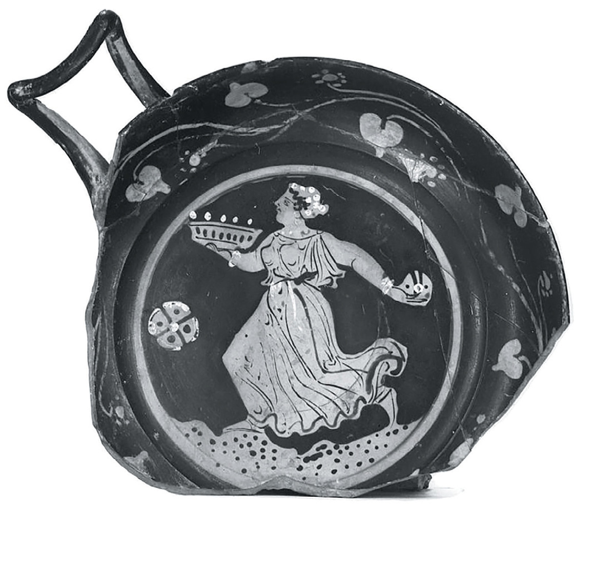 This Hellenistic kylix (drinking cup) dates back to 350-300 B.C.E., with an image perhaps depicting an amphiphon, or other offering cake, lit with candles. Courtesy of the Ure Museum of Greek Archeology. Accession number 22.3.24